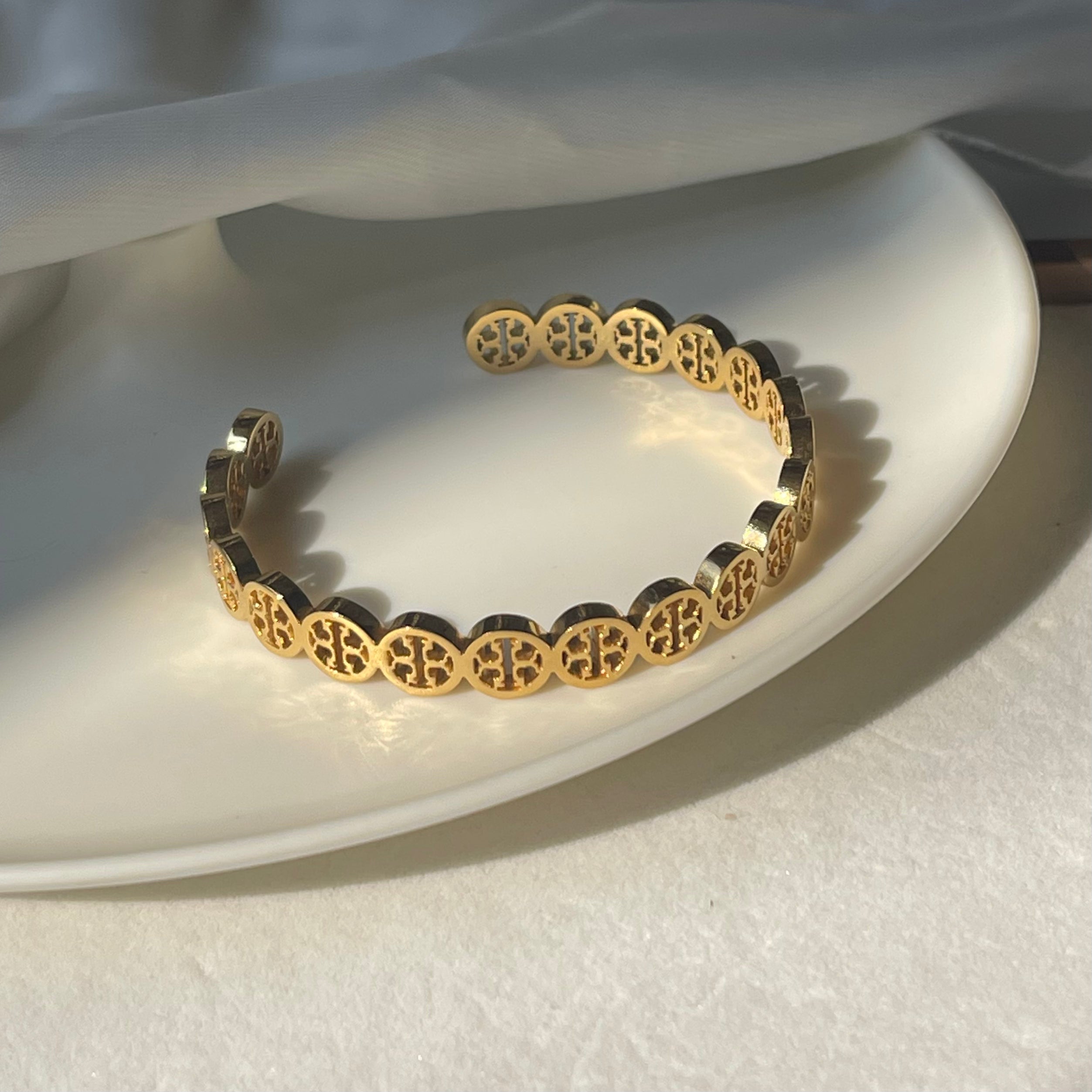 Gold Toned Pierced Hand cuff