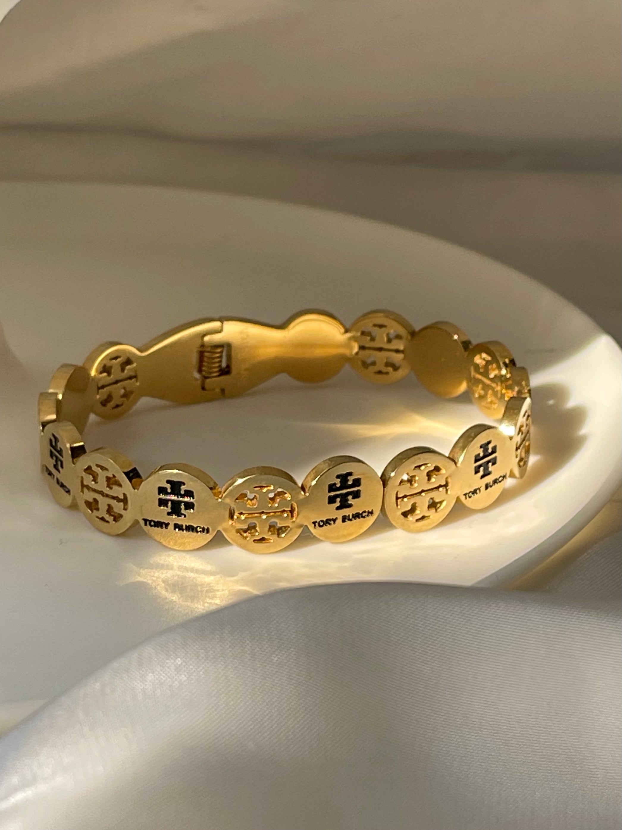 Gold toned twirl bangle